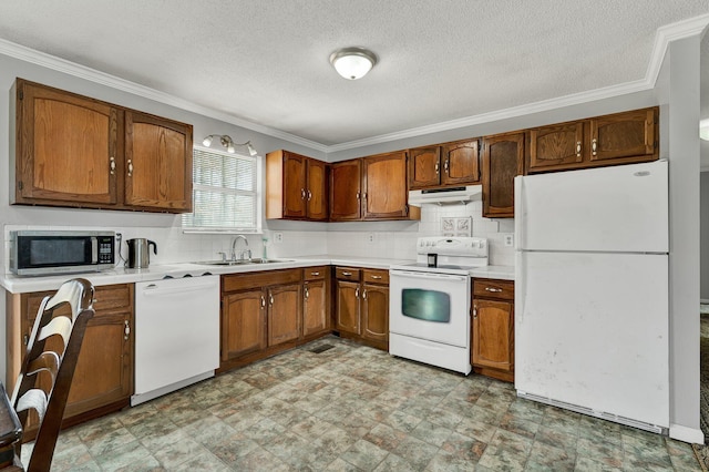 kitchen with light countertops, brown cabinetry, a sink, white appliances, and under cabinet range hood