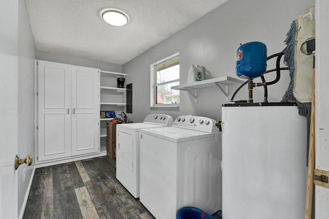 laundry room featuring a textured ceiling, gas water heater, laundry area, dark wood-type flooring, and washer and clothes dryer