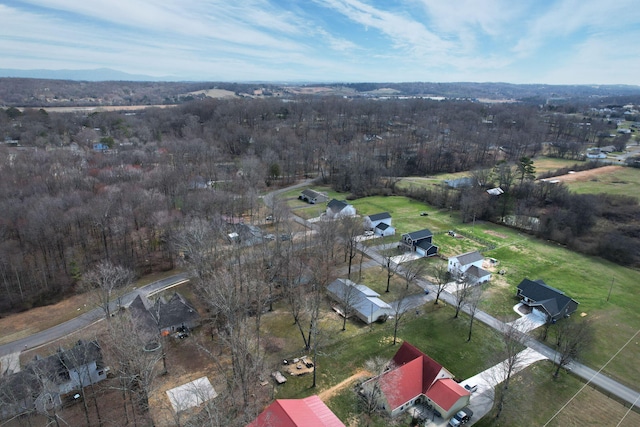 birds eye view of property with a view of trees