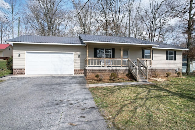 ranch-style home featuring driveway, a porch, metal roof, an attached garage, and a front lawn