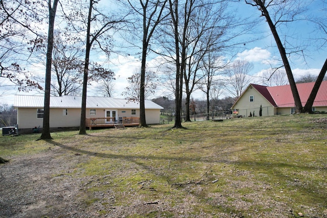 view of yard featuring fence and a deck