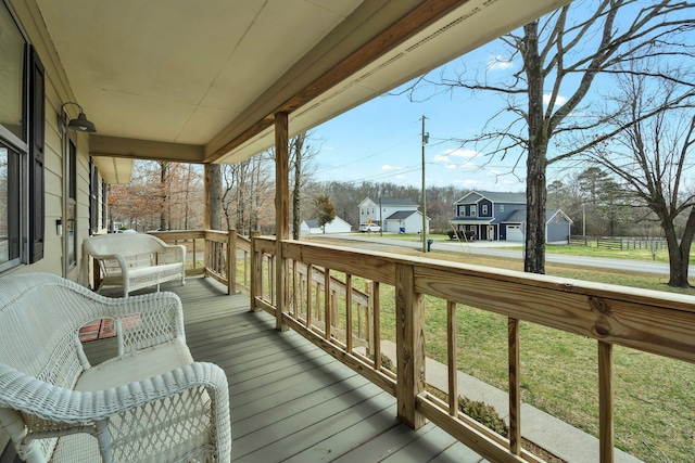 wooden terrace with a porch and a residential view