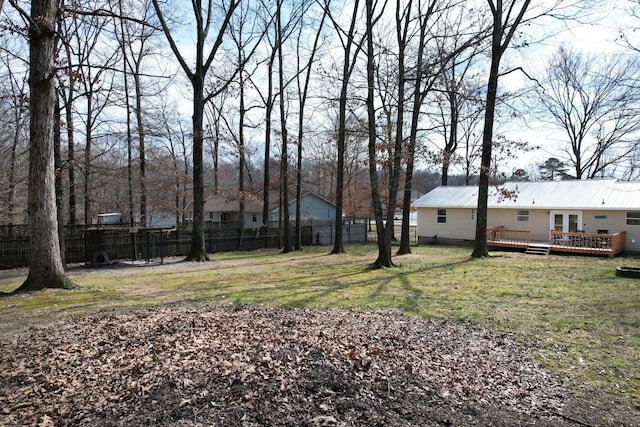 view of yard featuring fence and a wooden deck