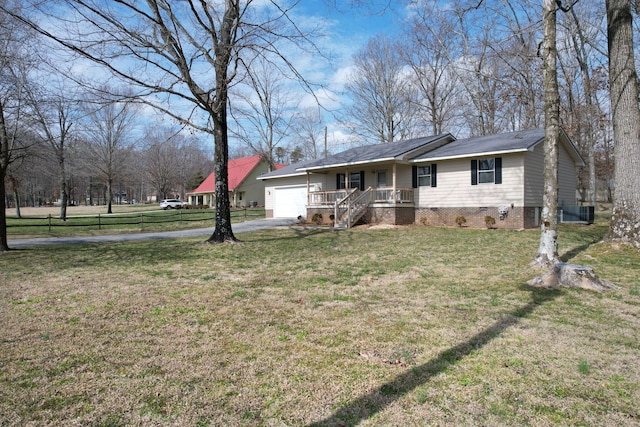 single story home featuring aphalt driveway, a porch, crawl space, a garage, and a front lawn