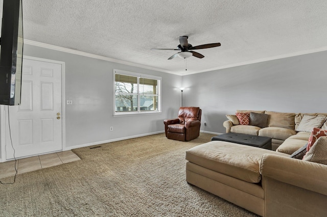 tiled living room with a textured ceiling, ornamental molding, carpet flooring, and a ceiling fan