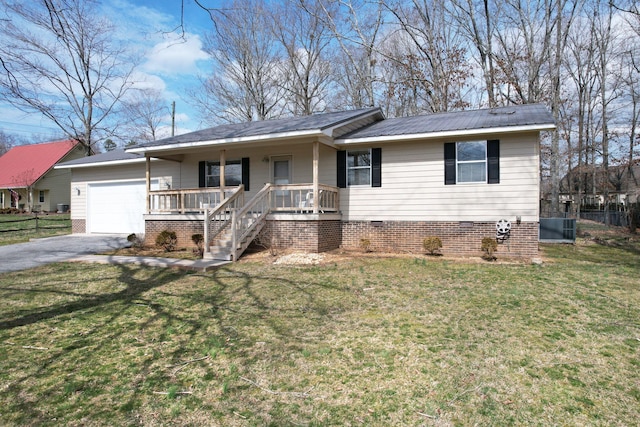 ranch-style house featuring a porch, an attached garage, fence, driveway, and a front yard