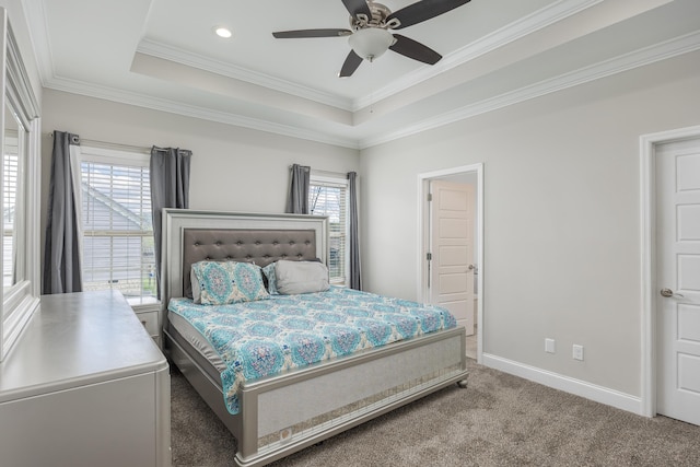 carpeted bedroom featuring ceiling fan, a raised ceiling, and multiple windows