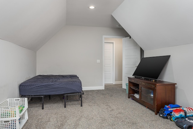 carpeted bedroom with lofted ceiling