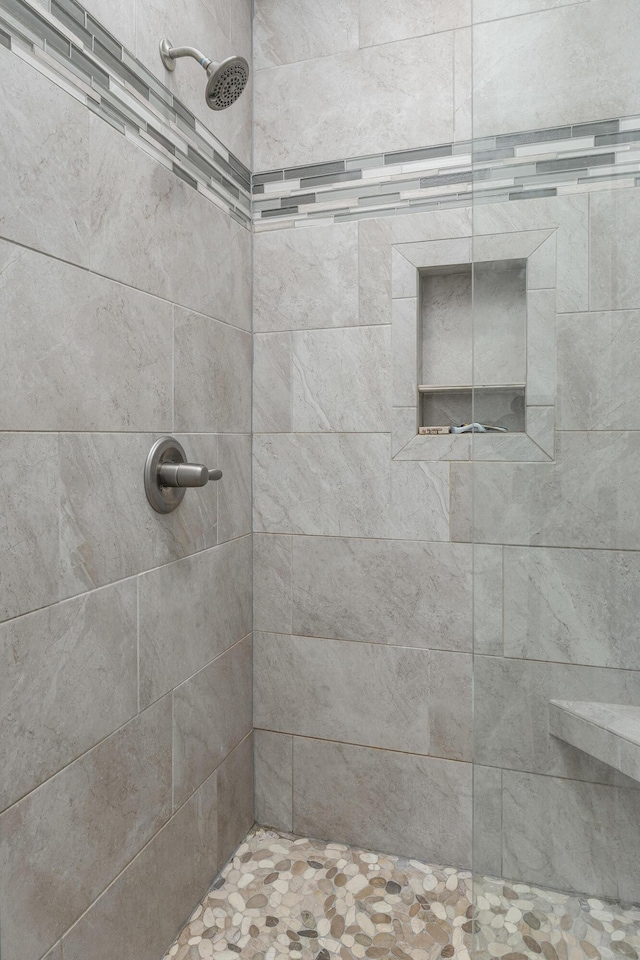 bathroom with tiled shower