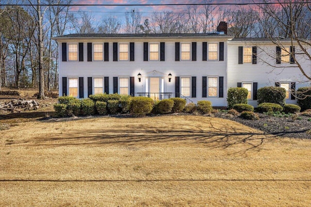 colonial inspired home with a chimney