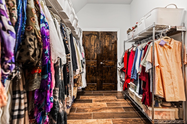 walk in closet with lofted ceiling and wood tiled floor