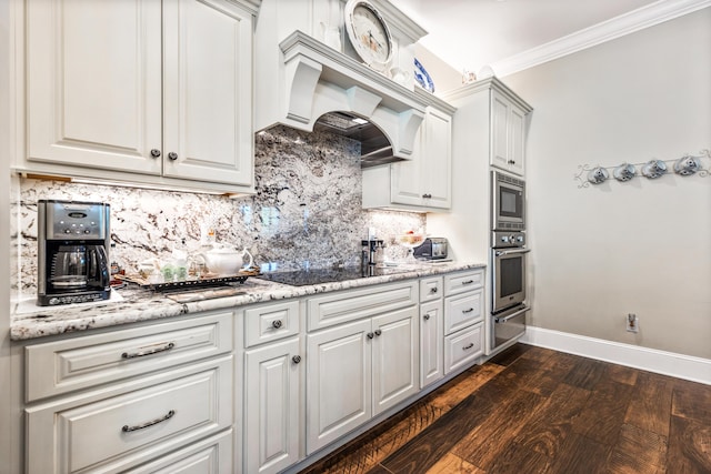 kitchen featuring white cabinets, appliances with stainless steel finishes, decorative backsplash, a warming drawer, and crown molding