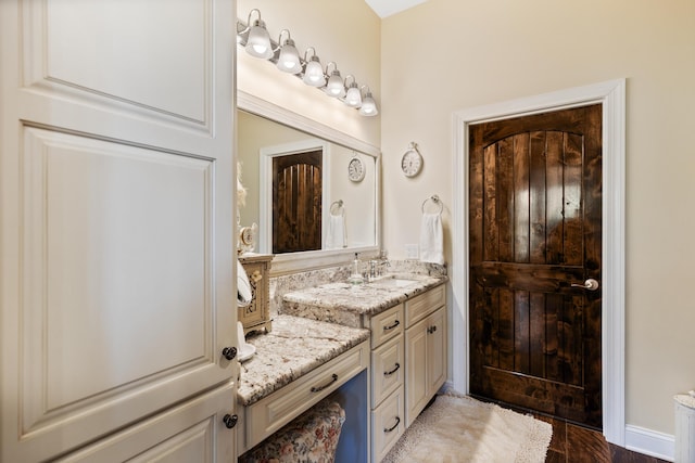 bathroom with wood finished floors and vanity