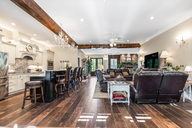 living area featuring dark wood-style floors, ornamental molding, beam ceiling, and recessed lighting