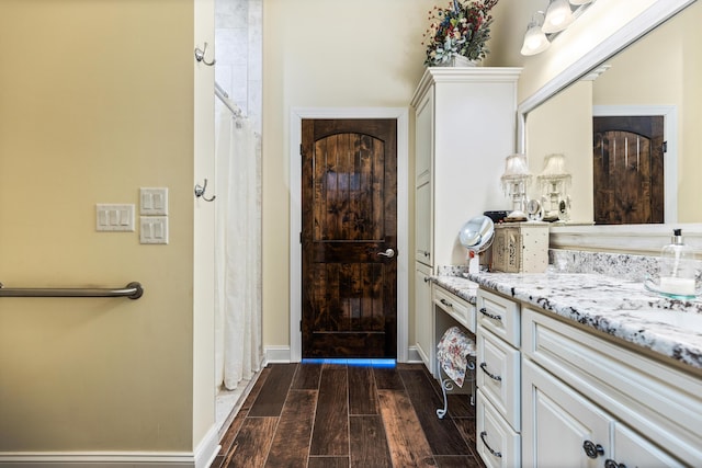 entryway with baseboards and dark wood-type flooring