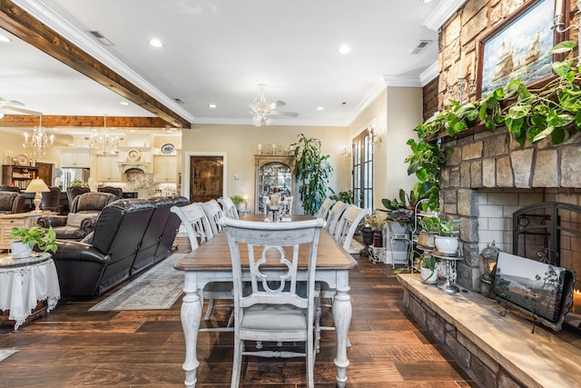 dining space with visible vents, dark wood finished floors, and a fireplace with raised hearth