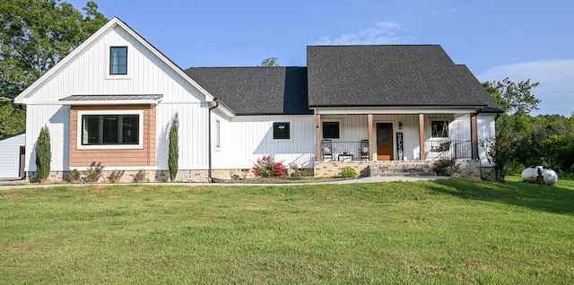 modern farmhouse with a front lawn and a porch