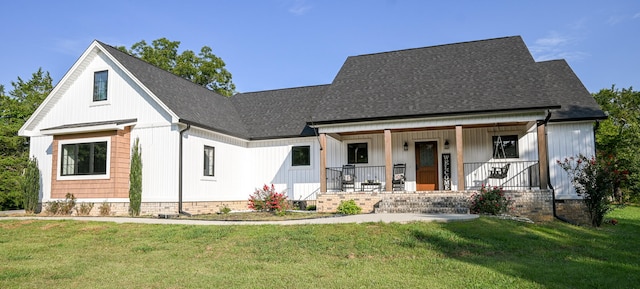 modern farmhouse style home with a front yard and a porch