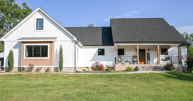 modern farmhouse featuring a porch and a front yard