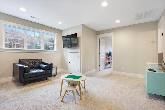 sitting room with light colored carpet