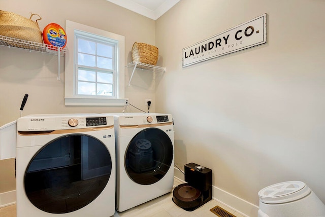 laundry area featuring independent washer and dryer and crown molding