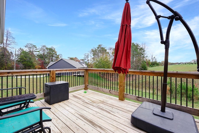 wooden deck featuring a yard