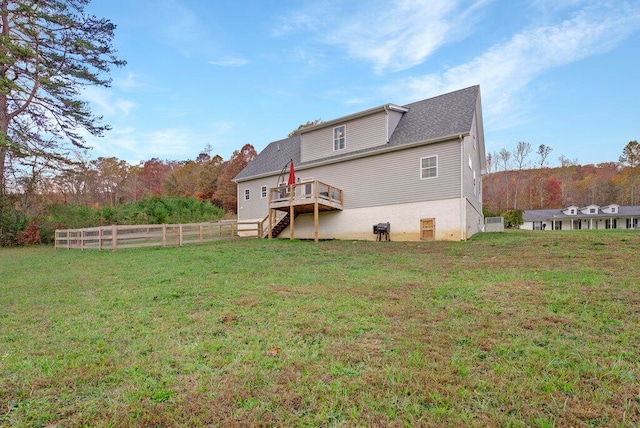 back of property featuring a yard and a wooden deck