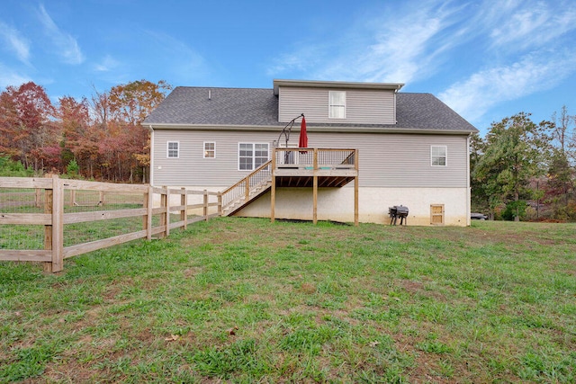 rear view of property with a lawn and a wooden deck