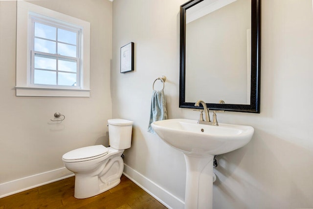 bathroom with wood-type flooring and toilet