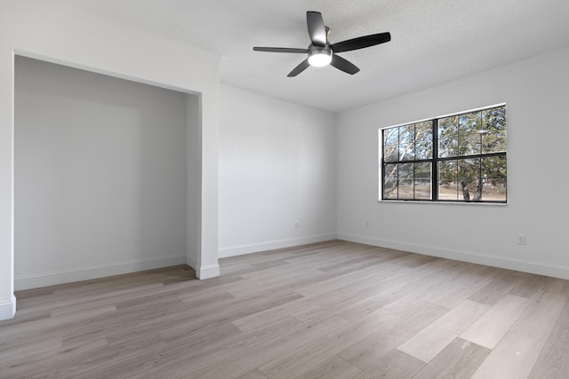 empty room featuring ceiling fan, a textured ceiling, and light hardwood / wood-style floors