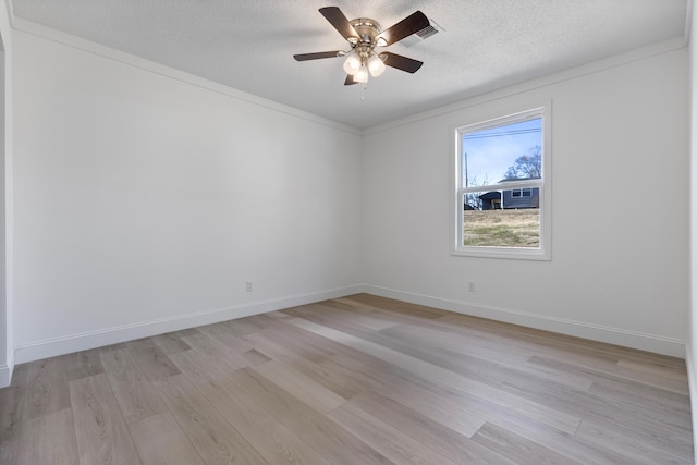 spare room featuring ceiling fan, a textured ceiling, and light wood-type flooring