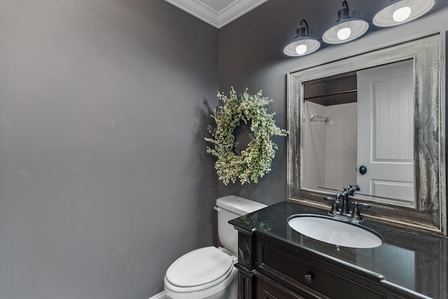 bathroom with toilet, crown molding, a shower, baseboards, and vanity