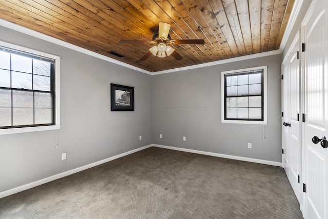 unfurnished bedroom featuring visible vents, carpet, baseboards, wood ceiling, and ornamental molding