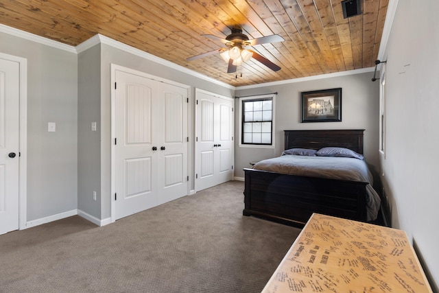 carpeted bedroom with wooden ceiling, two closets, crown molding, and baseboards