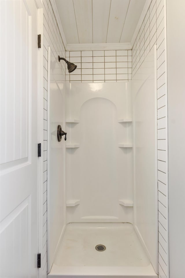 full bath with a stall shower and ornamental molding