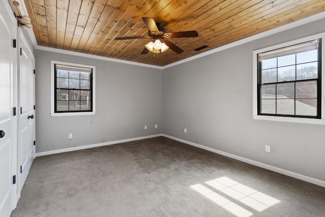 empty room with crown molding, visible vents, and ceiling fan