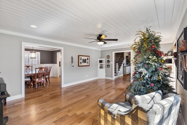 living room with light wood-style floors and crown molding