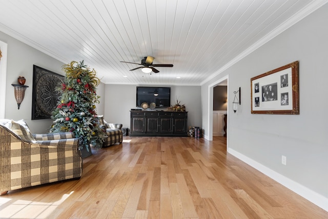 living room featuring a ceiling fan, baseboards, light wood-style flooring, crown molding, and wooden ceiling