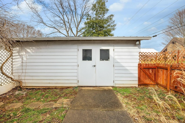 view of shed featuring fence