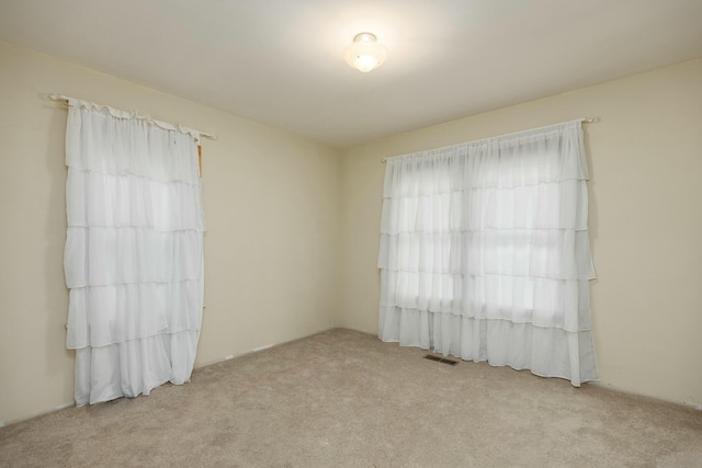 carpeted empty room with visible vents