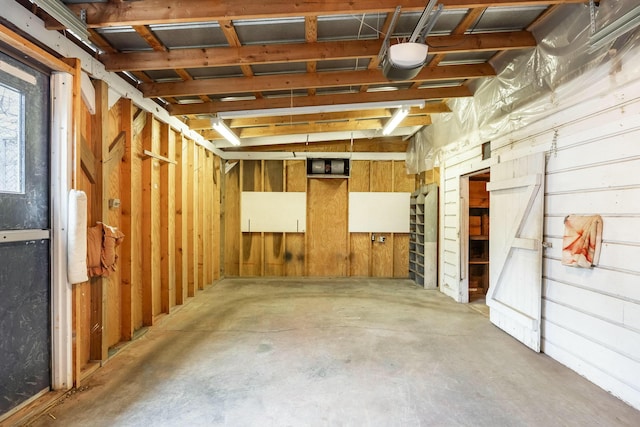 interior space featuring wooden walls and a garage