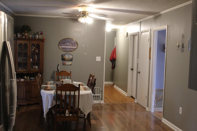 dining room featuring hardwood / wood-style flooring, ceiling fan, ornamental molding, and a textured ceiling