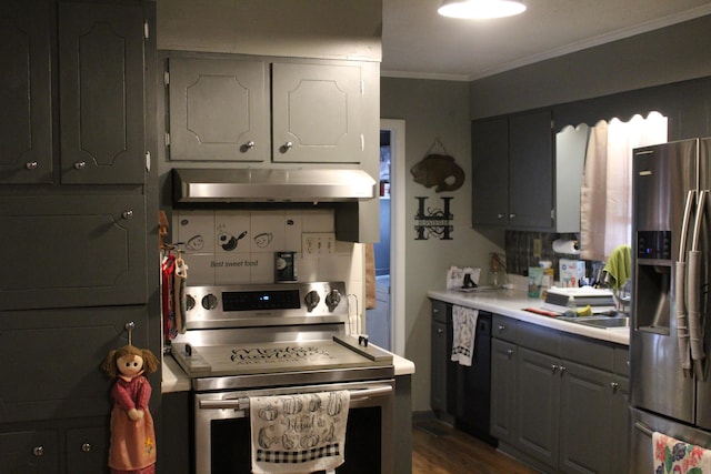 kitchen featuring appliances with stainless steel finishes, backsplash, gray cabinetry, crown molding, and dark hardwood / wood-style floors