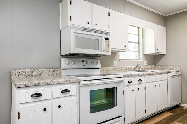 kitchen with white appliances, sink, ornamental molding, dark hardwood / wood-style flooring, and white cabinetry