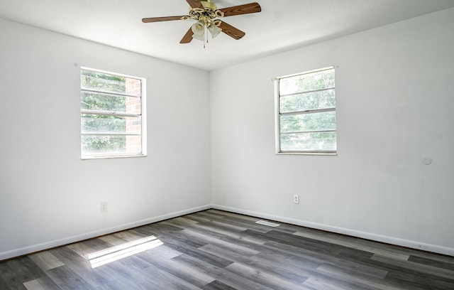 unfurnished room featuring ceiling fan and dark wood-type flooring