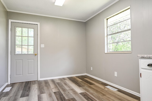 doorway featuring hardwood / wood-style flooring and crown molding