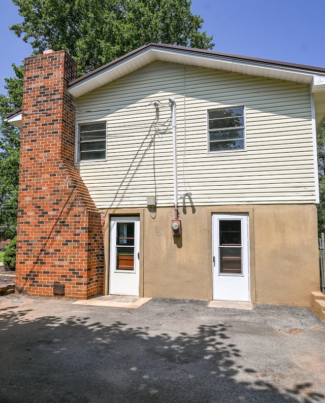 back of property with a patio