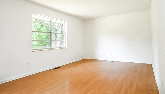 empty room with wood-type flooring