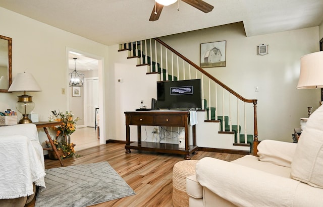 4901 Cindy Cir NW, Cleveland, TN 37312 - living area featuring stairs, wood finished floors, and a ceiling fan