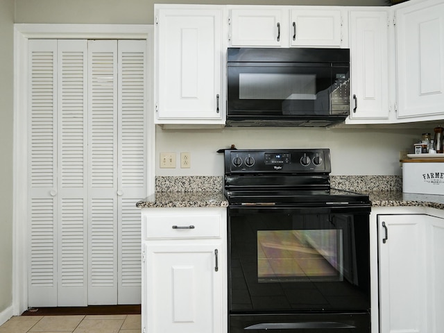 4901 Cindy Cir NW, Cleveland, TN 37312 - kitchen with black appliances, dark stone countertops, white cabinets, and light tile patterned flooring